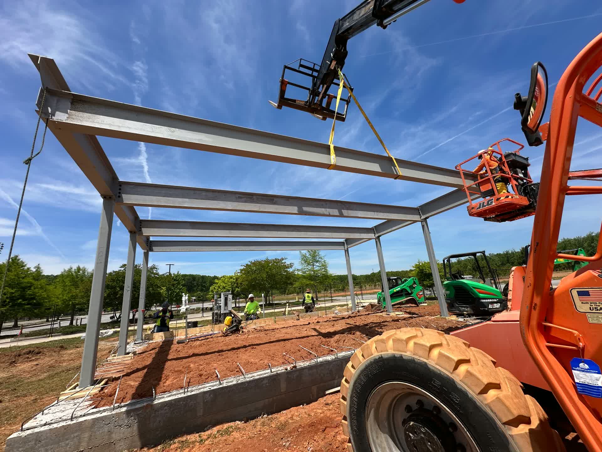 Setting steel beams for a canopy frame with a telehandler