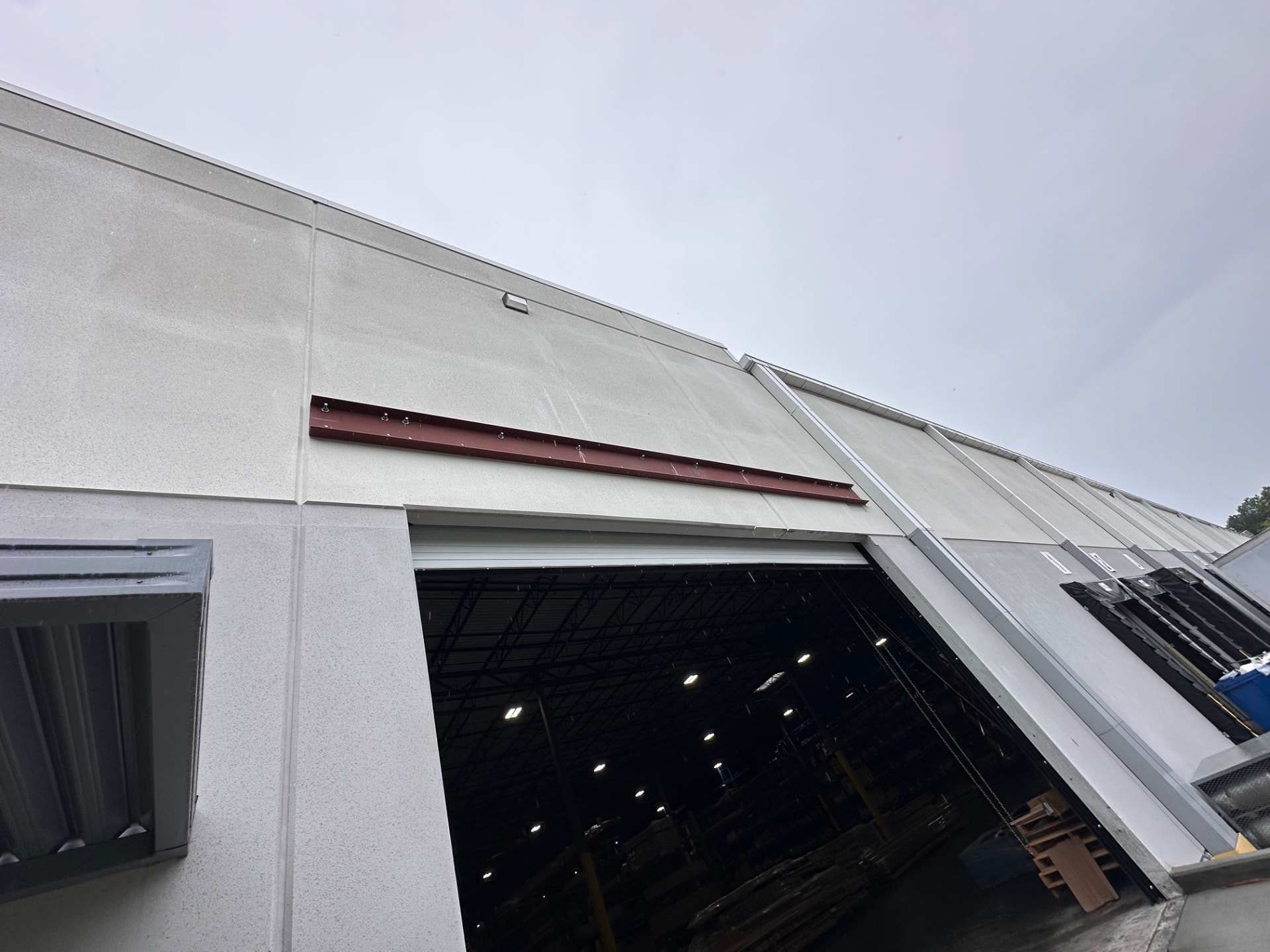 Red steel lintel above a loading bay door