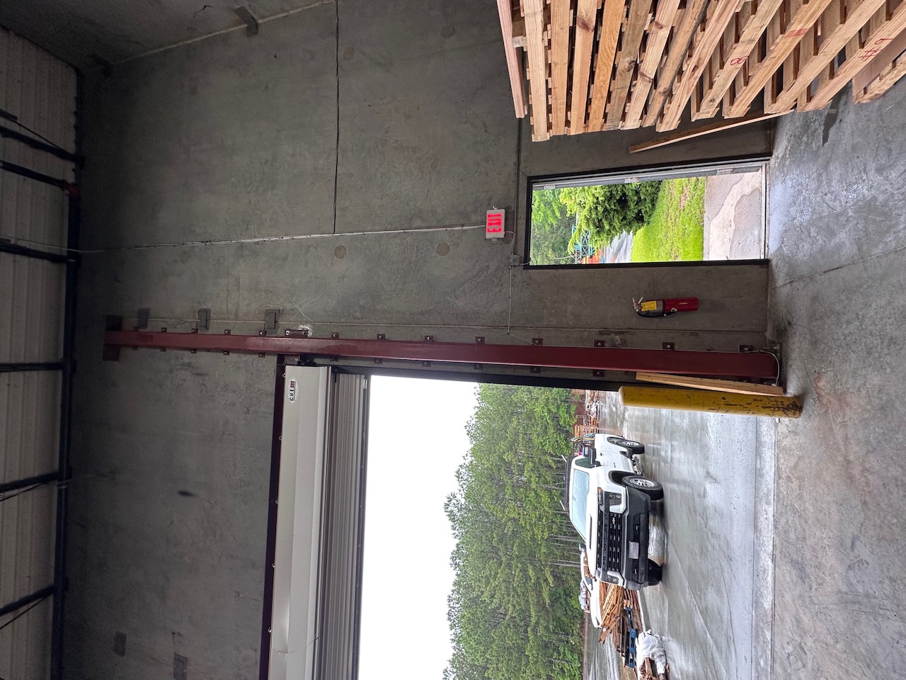 Red steel header beam inside a warehouse loading dock