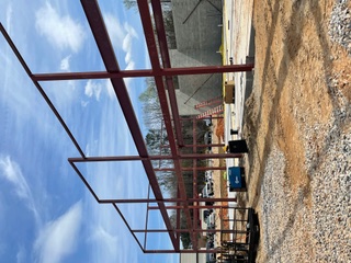 Long run of red steel columns and beams on a commercial site