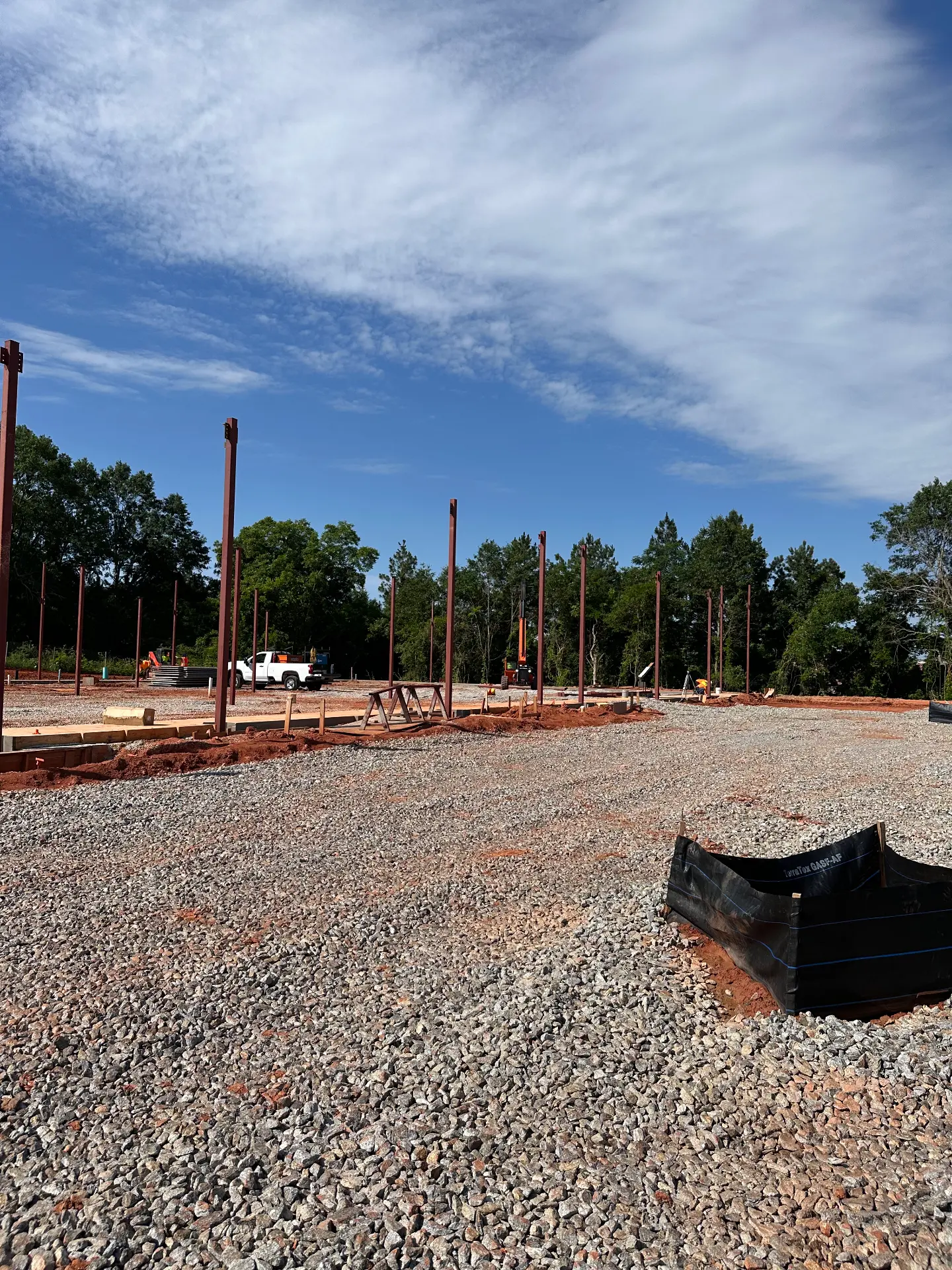 Field of red steel columns set on a commercial jobsite