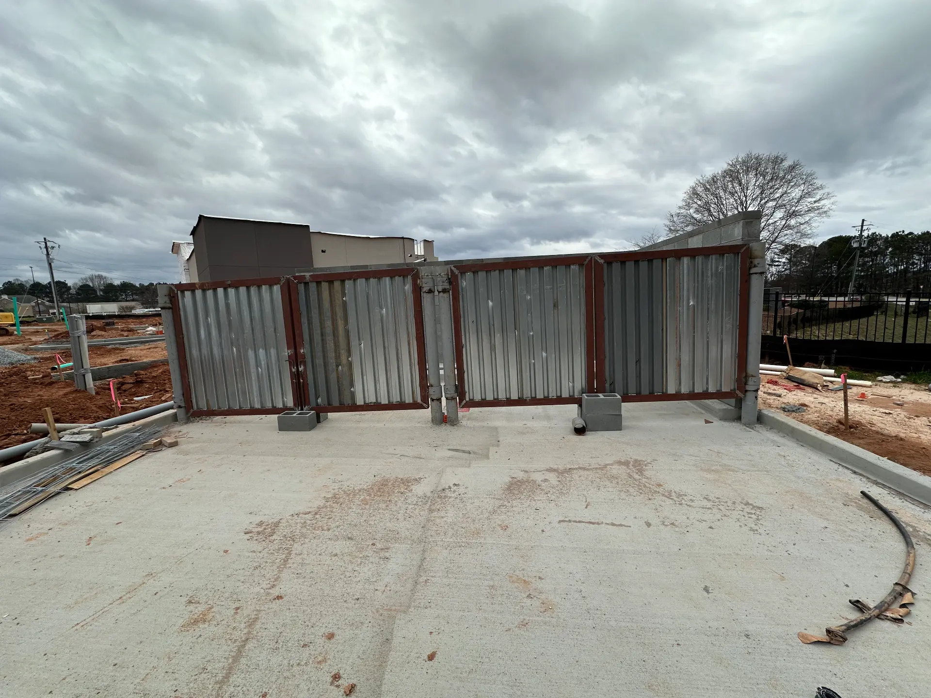 Galvanized dumpster enclosure gates in steel frames
