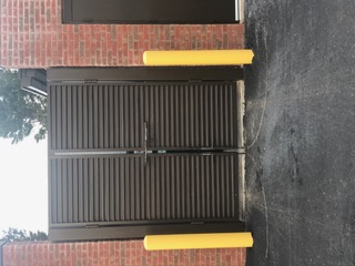 Louvered steel service gates with protective bollards