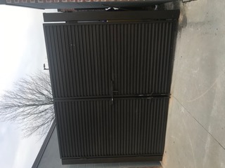Black louvered steel enclosure gates