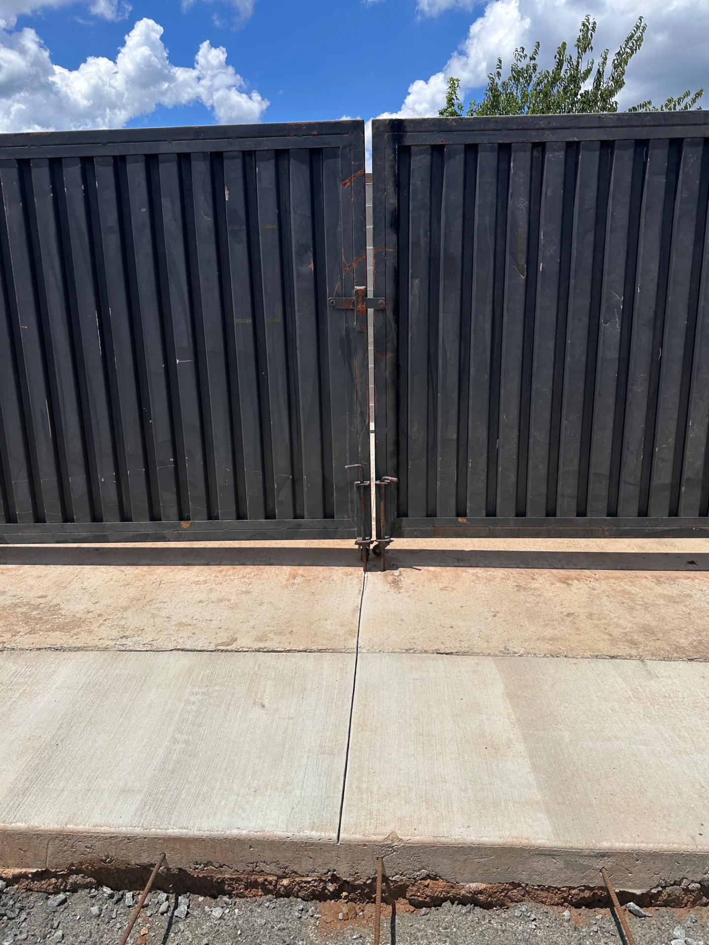Close-up of black steel gate locking hardware