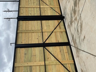 Steel-framed wood dumpster enclosure gates