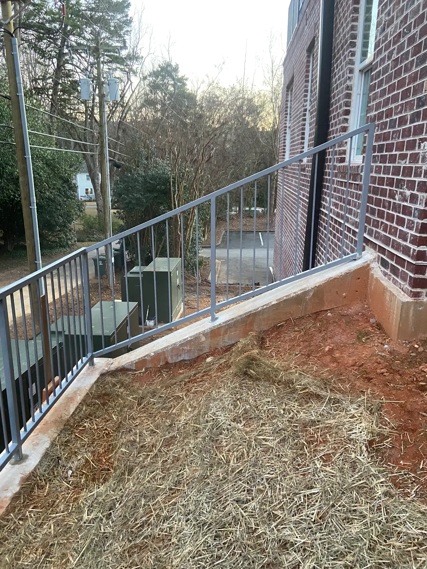 Steel guardrail installed along an elevated concrete wall
