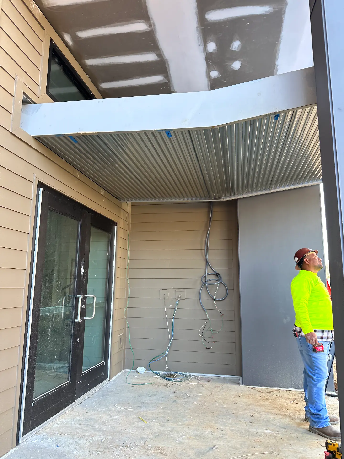Steel-framed entry canopy with metal deck soffit