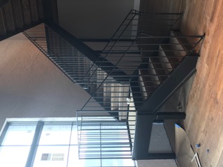 Black steel stair with picket railing in a commercial interior