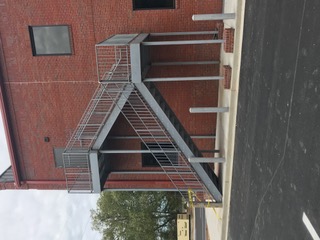 Galvanized exterior egress stair on a brick building