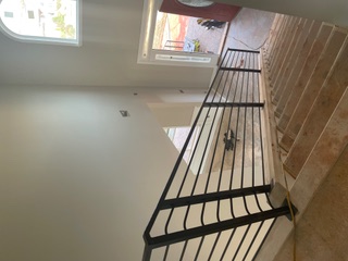 Horizontal bar steel stair railing in a residence